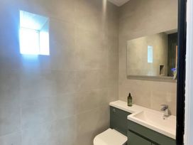 A bathroom with a sink and toilet at Storws Tanrallt Llanfachraeth