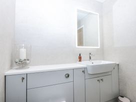 A bathroom with a sink and a mirror at 40 New Row Pwllheli