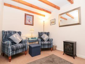 A snug area with two armchairs and a side table at The Old Cottage in Staithes
