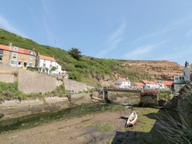 A view of houses and a bridge over a river at The Old Cottage in Staithes