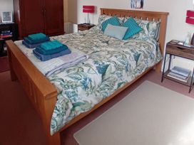 A bedroom with a bed and towels arranged at Emily's Retreat at the Great Barn, Great Dunham, Litcham