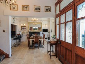A dining room with a table and chairs at Wavecrest in Pwllheli