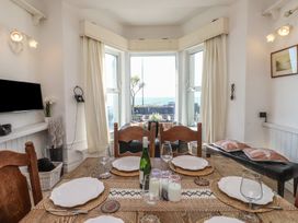 A dining room with a table set up at Wavecrest in Pwllheli