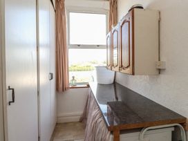 A utility room with a window and a countertop at Wavecrest in Pwllheli
