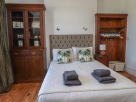 A bedroom with a bed and furniture at Wavecrest in Pwllheli