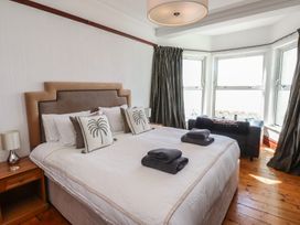A bedroom with a bed and bedside table at Wavecrest in Pwllheli