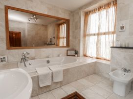 A bathroom with a bathtub and toilet at Wavecrest in Pwllheli