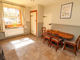 A dining room with a table and chairs at Gamekeepers Cottage in Chillingham near Chatton