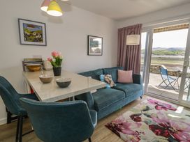 A living room with a sofa and table at Lan y Mor in Porthmadog