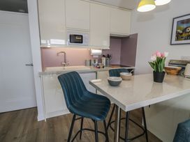 A kitchen with a sink and microwave at Lan y Mor in Porthmadog