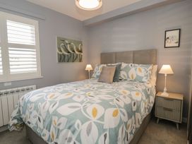 A bedroom with a bed and nightstand at Lan y Mor in Porthmadog