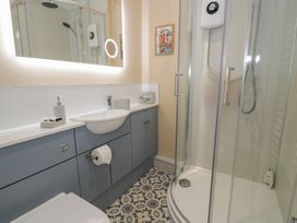 A bathroom with a sink and shower at Lan y Mor in Porthmadog