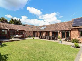 An outdoor area with seating and table at The Old Byres in Washford near Watchet