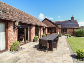 An outdoor dining area with a table and chairs at The Old Byres Washford near Watchet