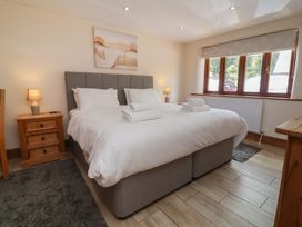 A bedroom with a double bed and bedside table at The Old Byres in Washford near Watchet