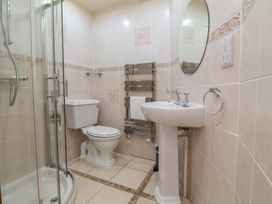 A bathroom with a shower, toilet and sink at The Old Byres Washford near Watchet