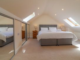 A bedroom with a large bed and bedside tables at The Old Byres in Washford near Watchet