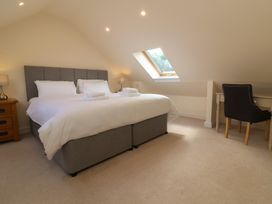 A bedroom with a bed and desk at The Old Byres in Washford near Watchet