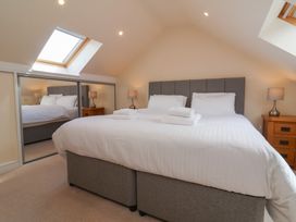 A bedroom with a double bed and bedside tables at The Old Byres in Washford near Watchet