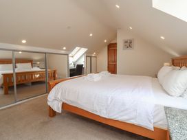 A bedroom with a bed and desk at The Old Byres in Washford near Watchet