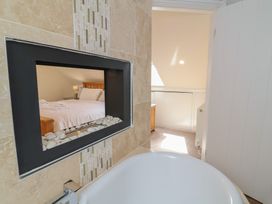 A bathroom with a view of a bedroom at The Old Byres Washford near Watchet