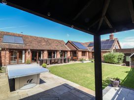A garden with a ping pong table and outdoor dining set at The Old Byres Washford near Watchet