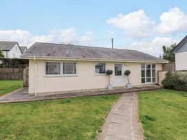 A bungalow with a pathway and garden at The Bungalow Morfa Nefyn near Pwllheli