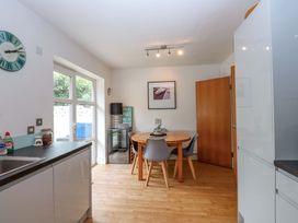 A kitchen with a dining table and chairs at The Bungalow in Morfa Nefyn near Pwllheli