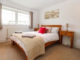 A bedroom with a bed and bedside tables at The Bungalow in Morfa Nefyn near Pwllheli