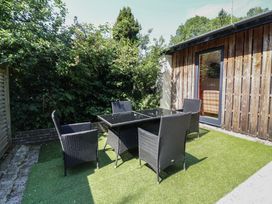 An outdoor seating area with a table and chairs at Zeal Cottage in Crediton