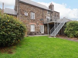 An outdoor view of a building with stairs and garden at Tower House in Boscastle