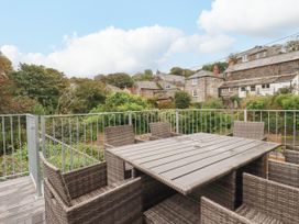 A dining table with chairs in an outdoor area at Tower House in Boscastle
