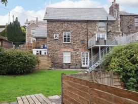 A stone house with garden and decking area at Tower House in Boscastle