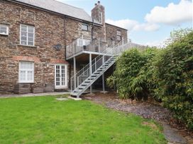 A garden with stairs and brick wall at Tower House in Boscastle