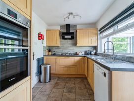 A kitchen with cabinets and appliances at Mylnebeck Lodge in Bowness-on-Windermere