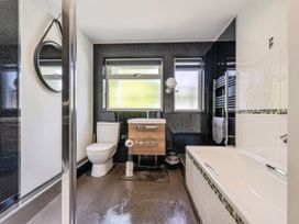 A bathroom with a sink, toilet, shower, and bathtub at Mylnebeck Lodge in Bowness-on-Windermere