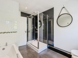 A bathroom with a shower and bathtub at Mylnebeck Lodge in Bowness-on-Windermere