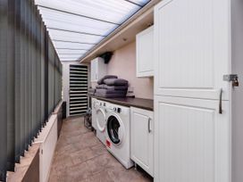 A laundry room with a washing machine and tumble dryer at Mylnebeck Lodge in Bowness-on-Windermere