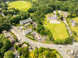 An aerial view of a residential area with buildings and greenery at Mylnebeck Lodge in Bowness-on-Windermere