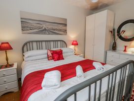 A bedroom with a bed and lamps at Blaenywawr near Lampeter