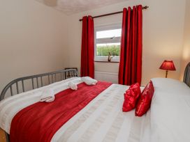 A bedroom with a bed and pillows at Blaenywawr near Lampeter