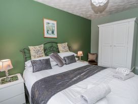 A bedroom with a bed and wardrobe at Blaenywawr near Lampeter