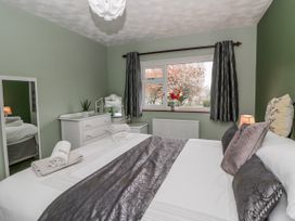 A bedroom with a bed and dresser at Blaenywawr near Lampeter