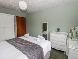 A bedroom with a bed and wardrobe at Blaenywawr near Lampeter