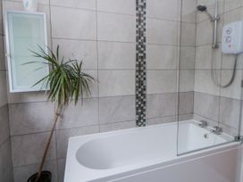A bathroom with a bathtub and showerhead at Blaenywawr near Lampeter