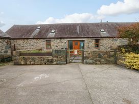 An outdoor view of a stone building with a gate at Beudy Mawr Y Felinheli