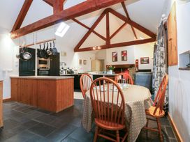 A kitchen with a dining table and chairs at Beudy Mawr Y Felinheli