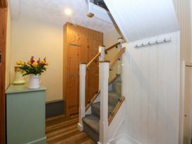 A hallway with a staircase and storage at Hafod Y Felinheli