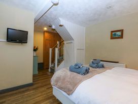 A bedroom with a bed and television at Hafod Y Felinheli