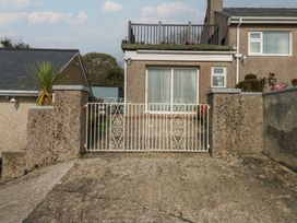 An outdoor area with a gate and a house front at Maesawel Studio in Llanfair